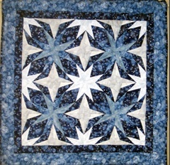 This paper pieced wallhanging was made using Carol Doak's pattern "Laurel" from her book 40 Bright & Bold Stars.Top & backing are constructed using quality 100% cotton, batting is low loft polyester. Machine pieced and machine quilted by Linda Monasky. 